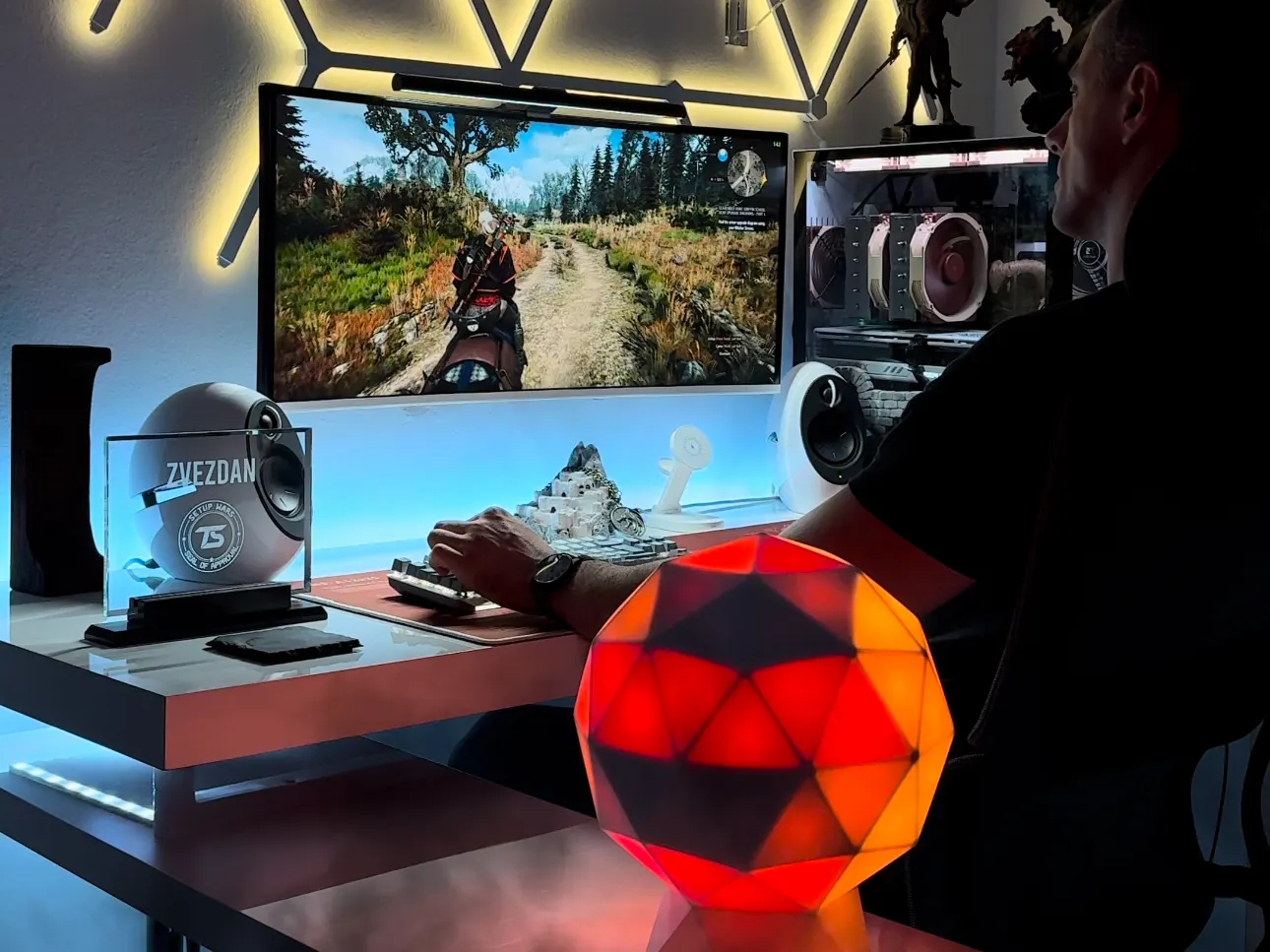 A GLORB lit orange on a desk in a display setup