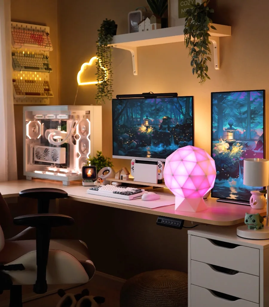GLORB lit pink on a desk setup with a white PC and dual monitors